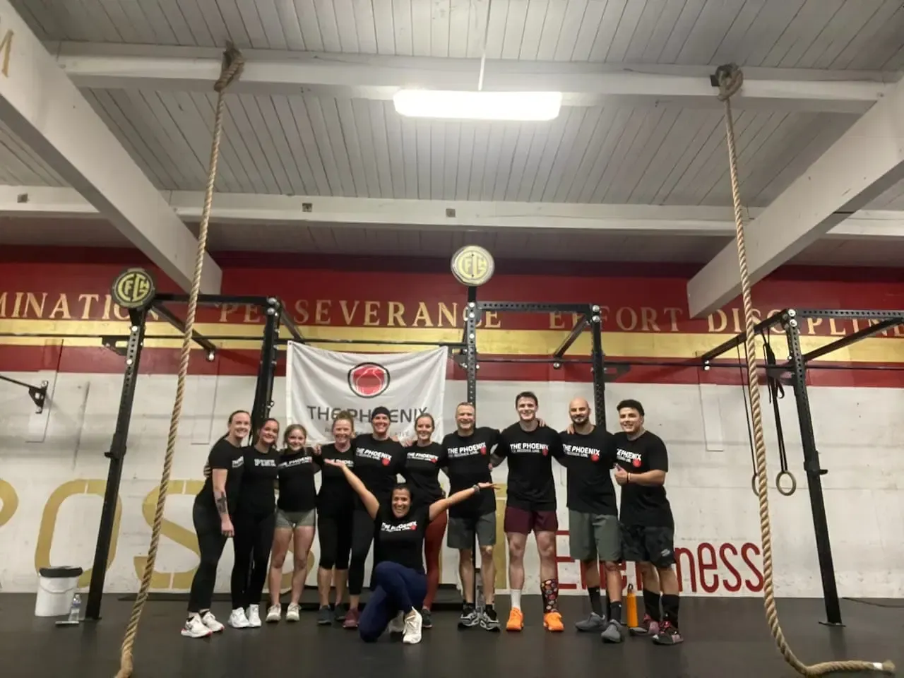A group of people posing for a picture in a gym