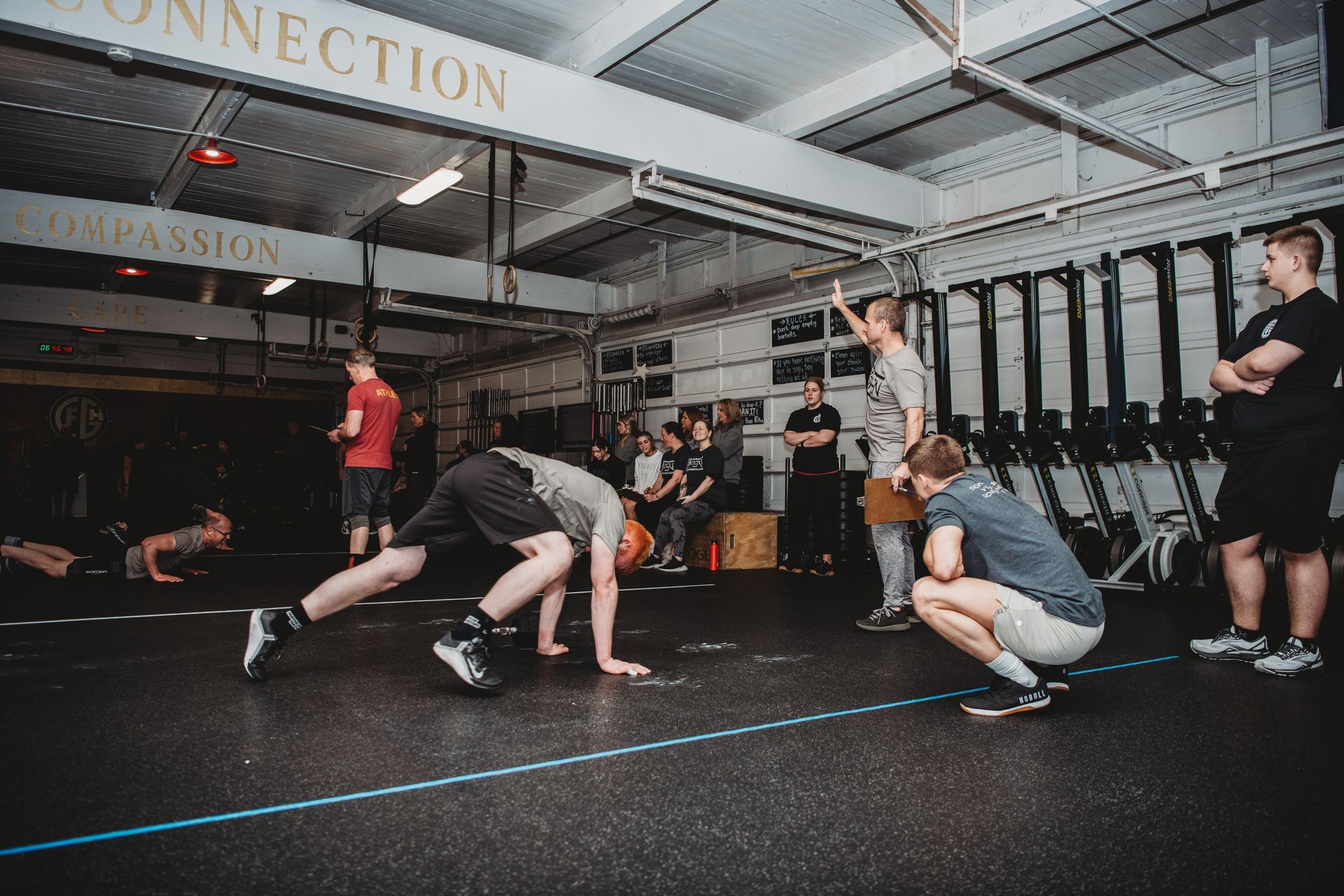 A group of men are doing push ups in a gym.