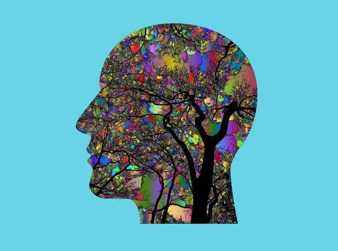 A colorful drawing of a man 's head with a tree in the middle.