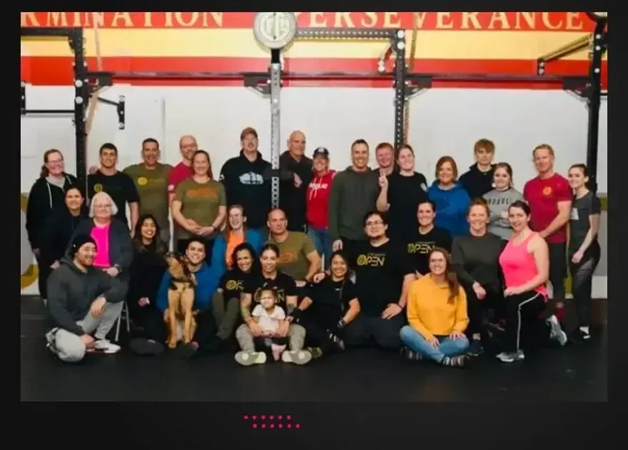 A group of people posing for a picture in front of a sign that says perseverance