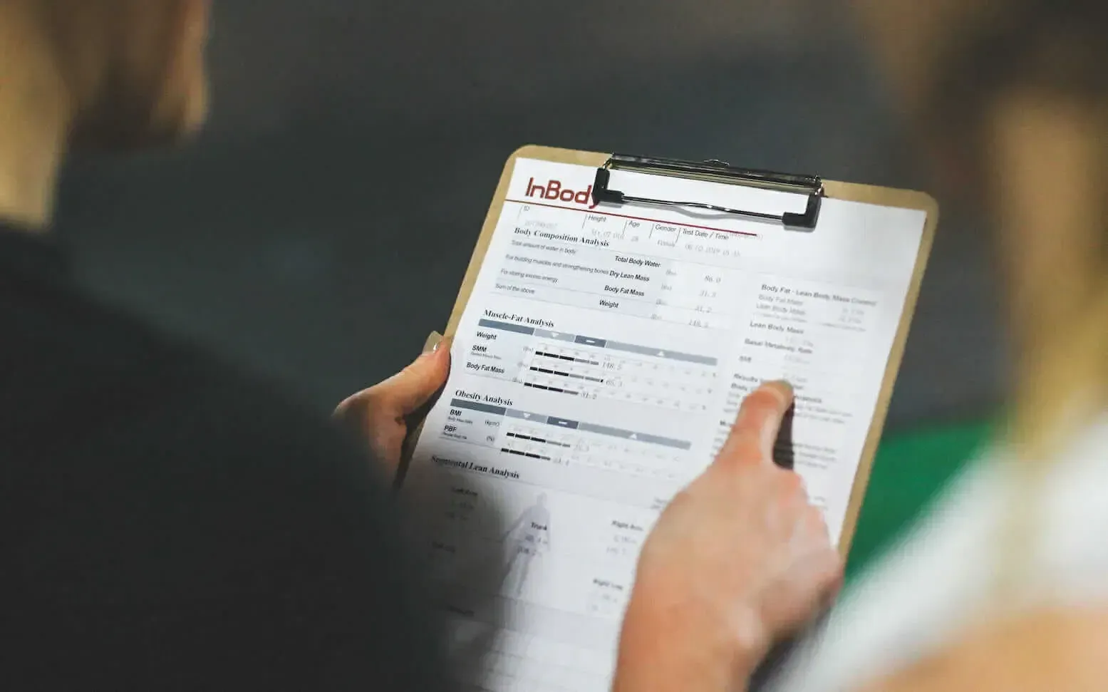 A person is holding a clipboard with a list on it.