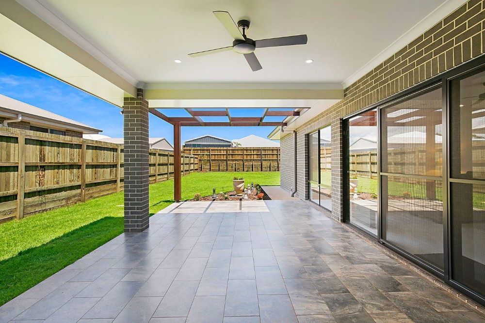 An Patio with A Ceiling Fan and Fence — Windamere Homes in Highfields, QLD