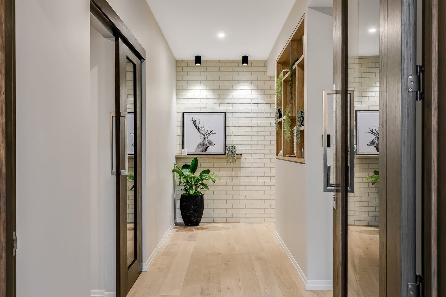 A Hallway With a Brick Wall and a Sliding Glass Door — Windamere Homes in Highfields, QLD