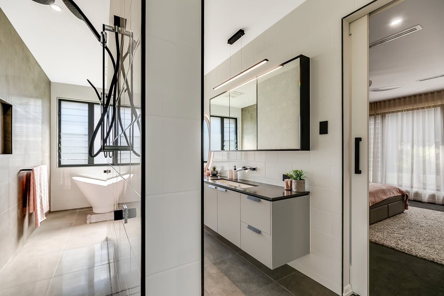 A Bathroom With Two Sinks, a Bathtub and a Mirror — Windamere Homes in Highfields, QLD