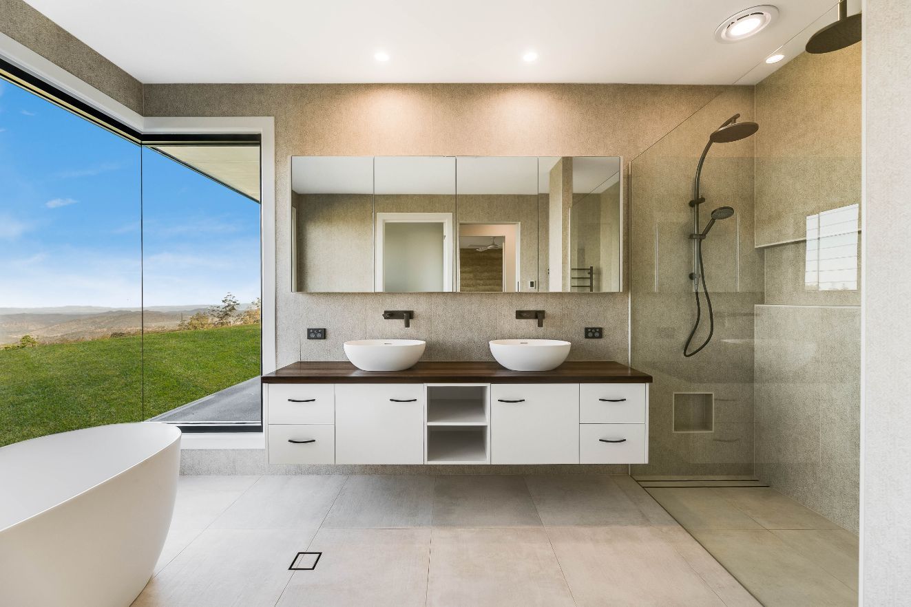 A Bathroom With Two Sinks and a Walk in Shower — Windamere Homes in Highfields, QLD