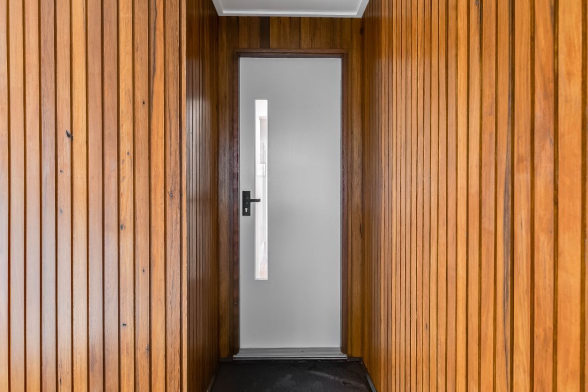 A White Door With a Window in the Middle of a Wooden Wall — Windamere Homes in Highfields, QLD