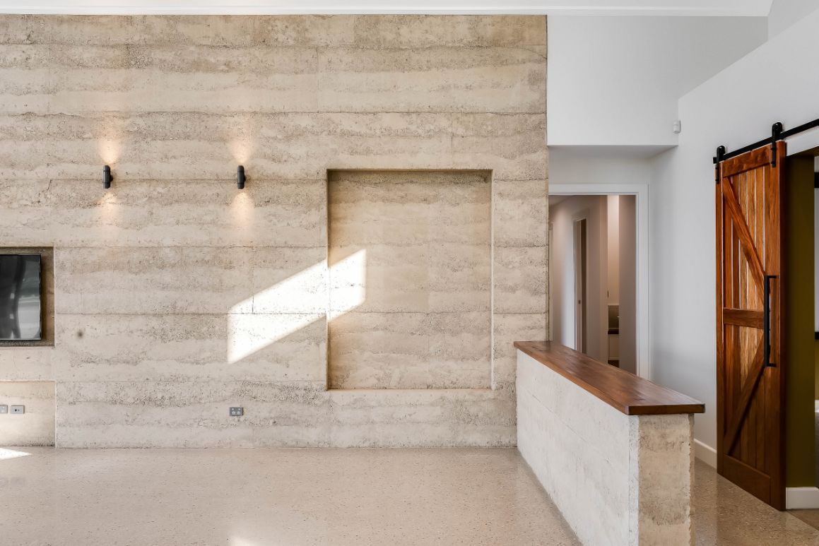 An Empty Room With a Brick Wall and a Wooden Counter — Windamere Homes in Highfields, QLD