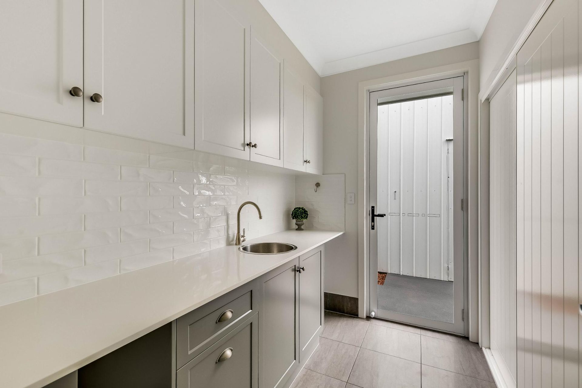A Kitchen With Cabinet and a Door — Windamere Homes in Highfields, QLD