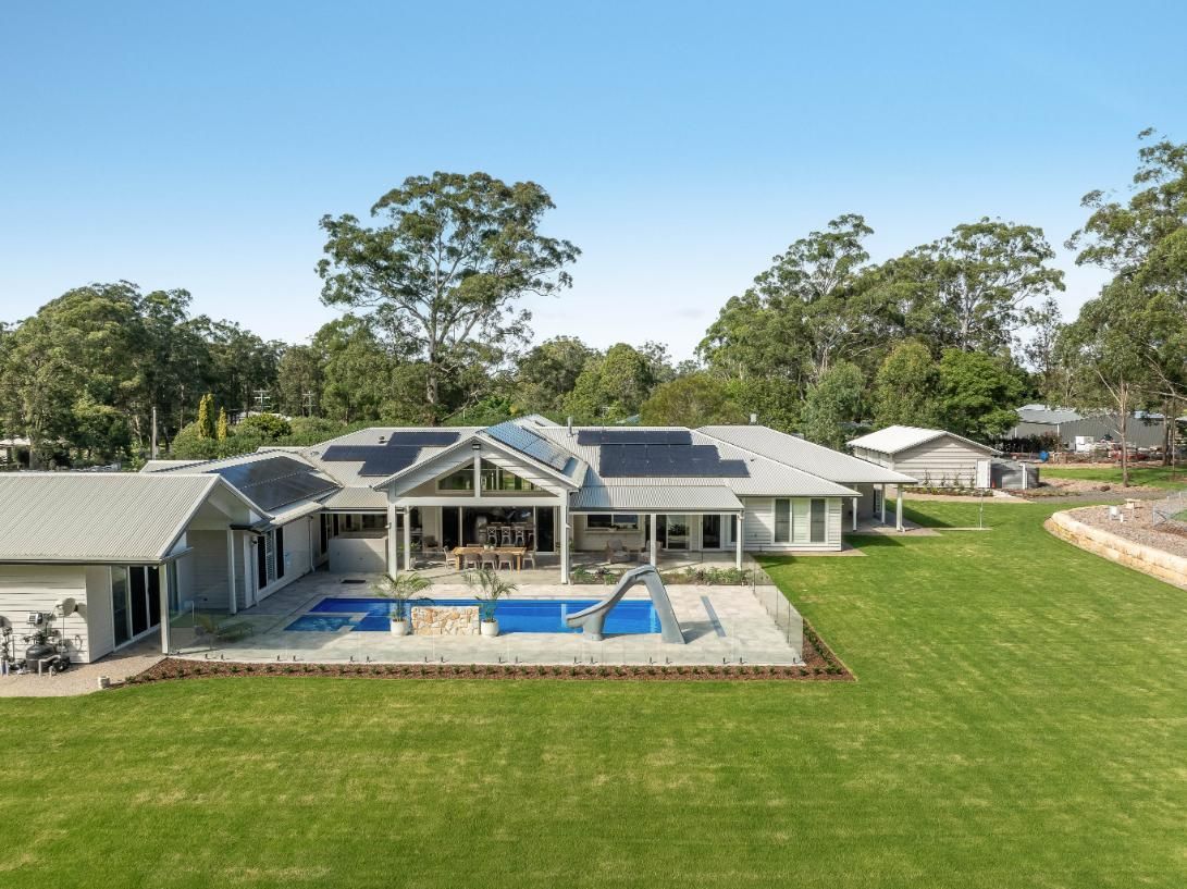An Aerial View of a Large House With a Swimming Pool in the Backyard — Windamere Homes in Highfields, QLD