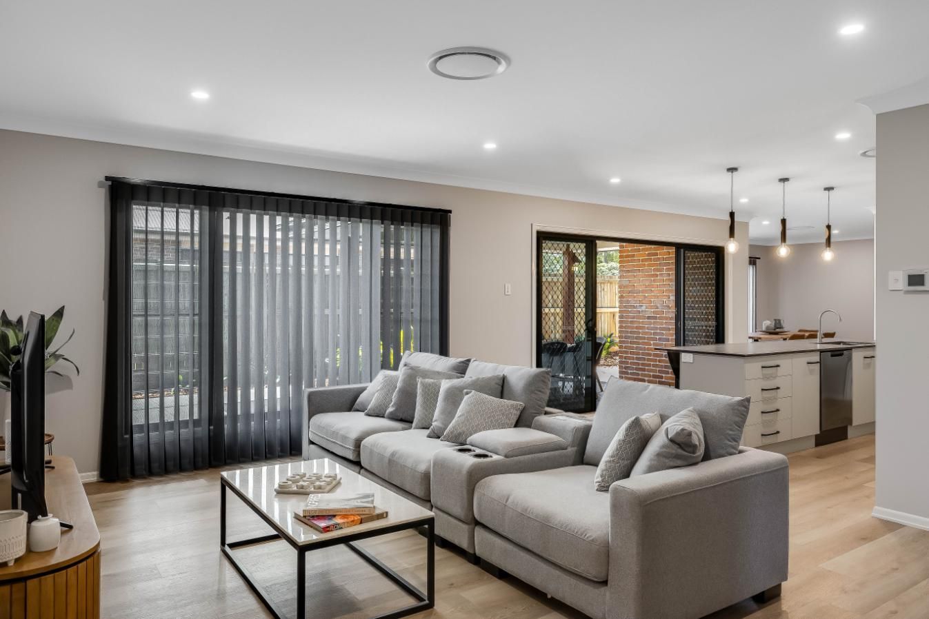 A Living Room With a Couch , Coffee Table — Windamere Homes in Highfields, QLD
