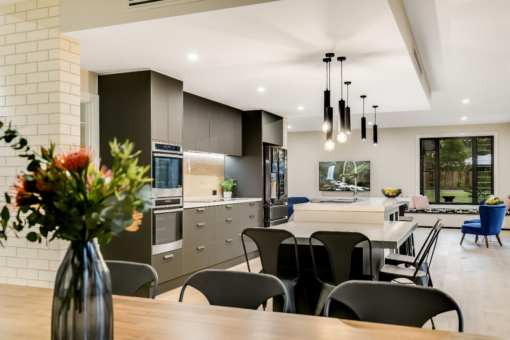 A Vase of Flowers is Sitting on a Table in a Kitchen — Windamere Homes in Highfields, QLD