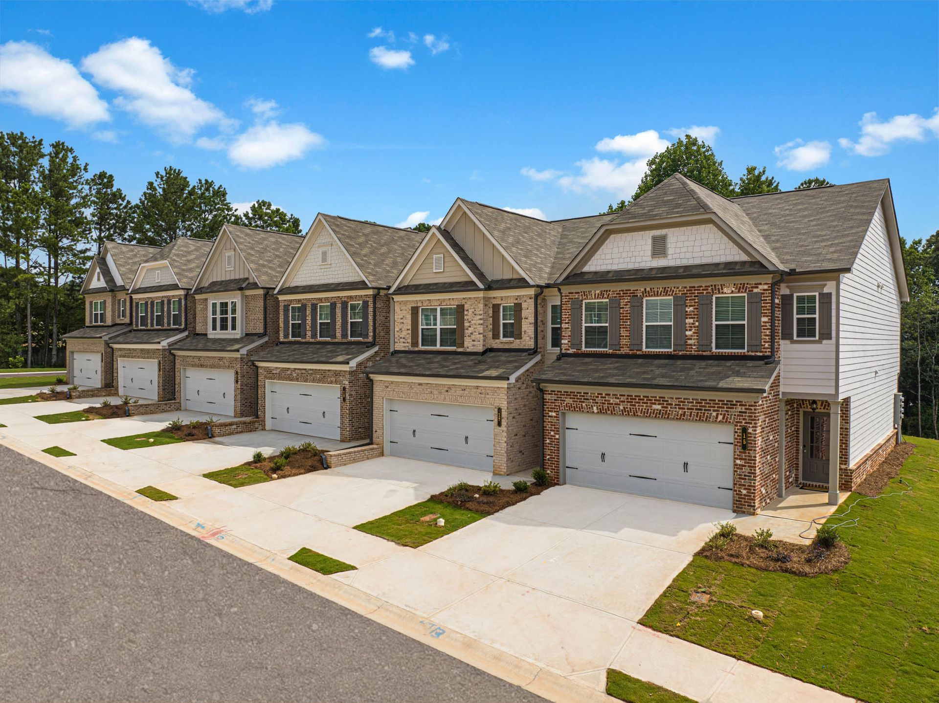 A row of houses with garages in a residential area at Collins Place.