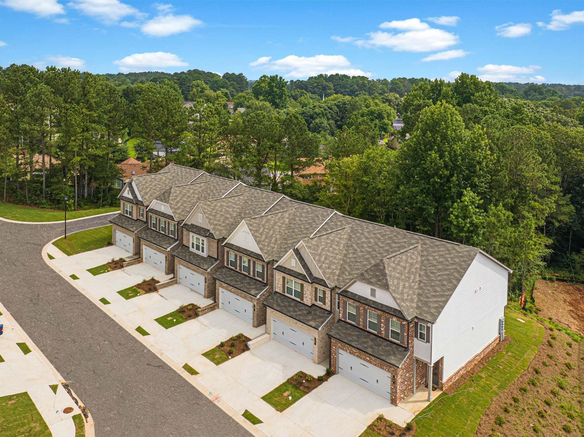 An aerial view of a row of houses with garages in a residential area at Collins Place.