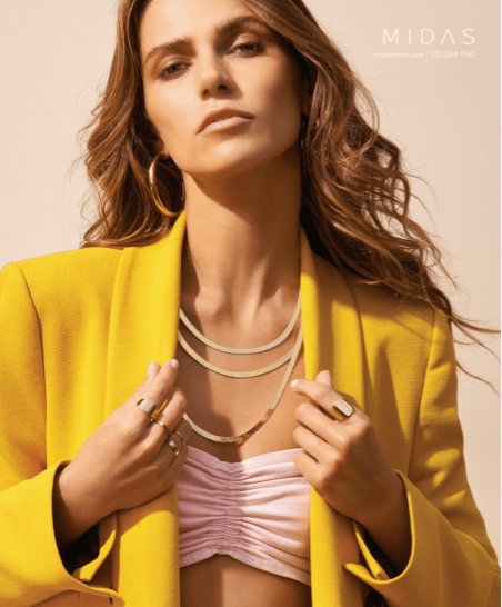 A woman is wearing a yellow jacket and a pink top