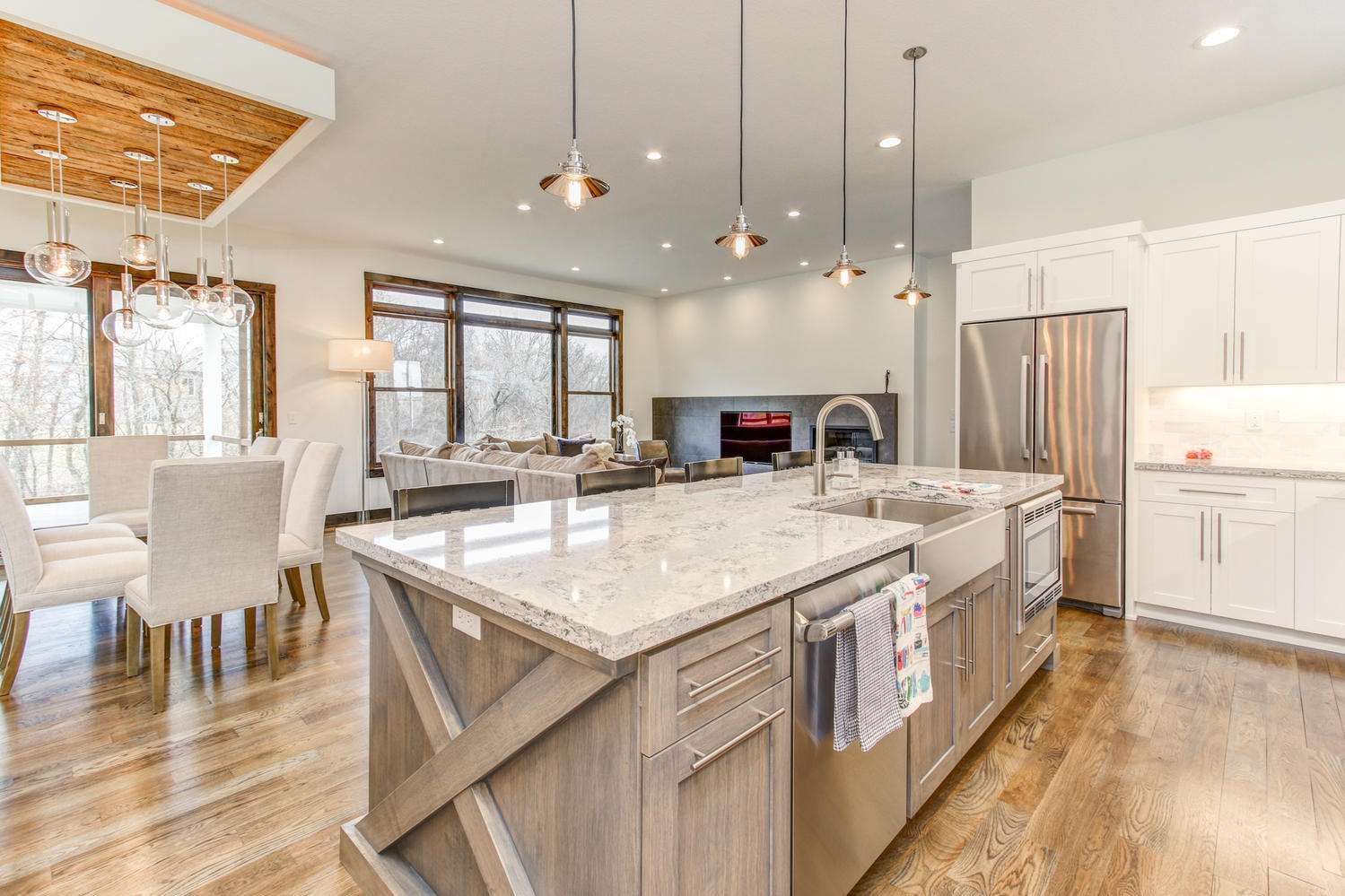 Spacious, modern kitchen with large island, stainless steel appliances, and adjacent dining area.
