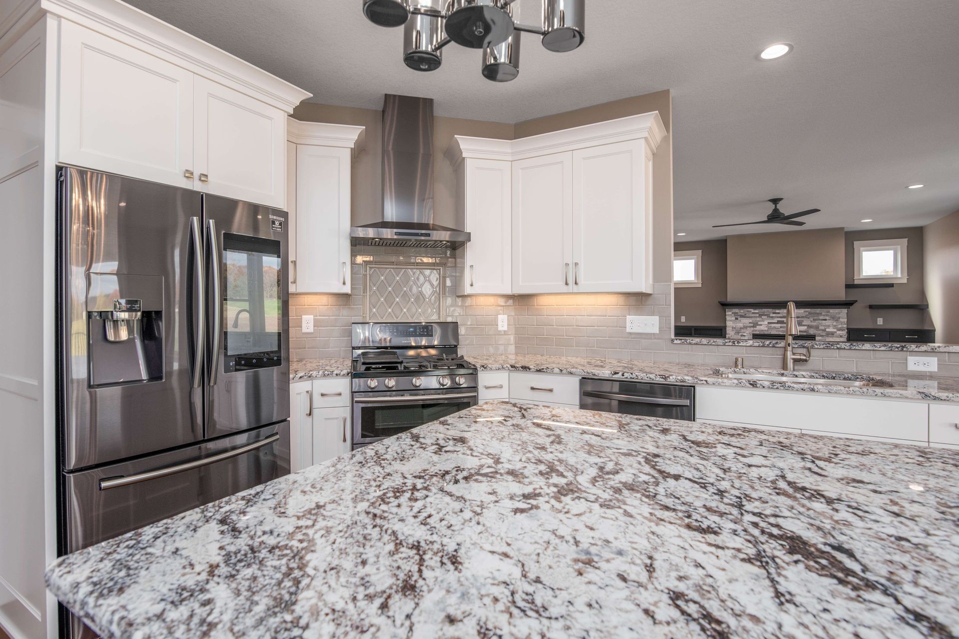 Kitchen with white cabinets, stainless steel appliances, and granite countertops.