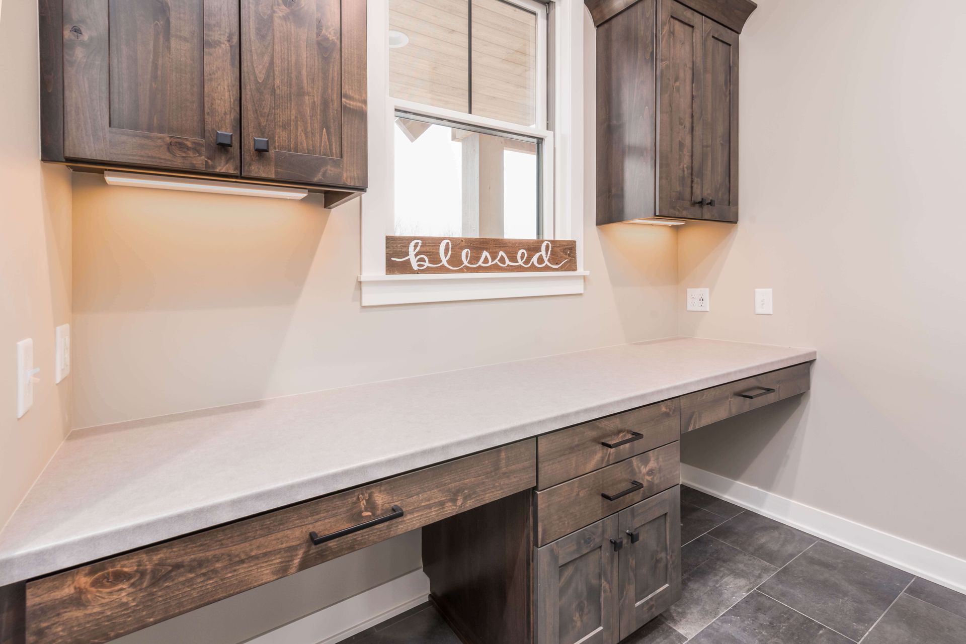 Dark wood desk with cabinets, a window with a 