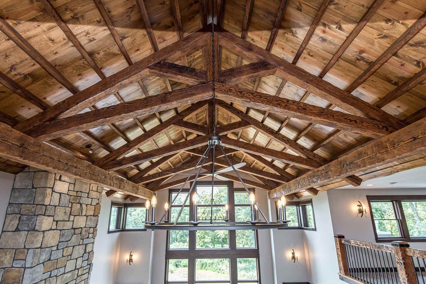 A large room with a wooden ceiling and a chandelier hanging from it