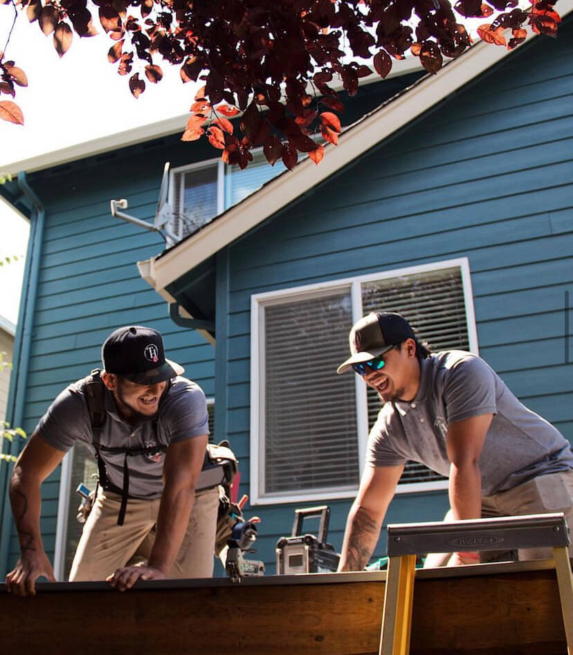 true hardscape team members dallas and pono working to create a wooden fence