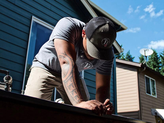 true hardscape founder dallas works outside to take measurements for a custom deck installation in hawaii