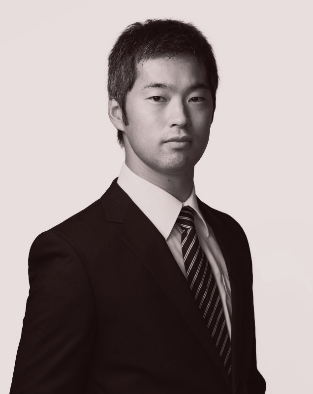 A man in a suit and tie is looking at the camera