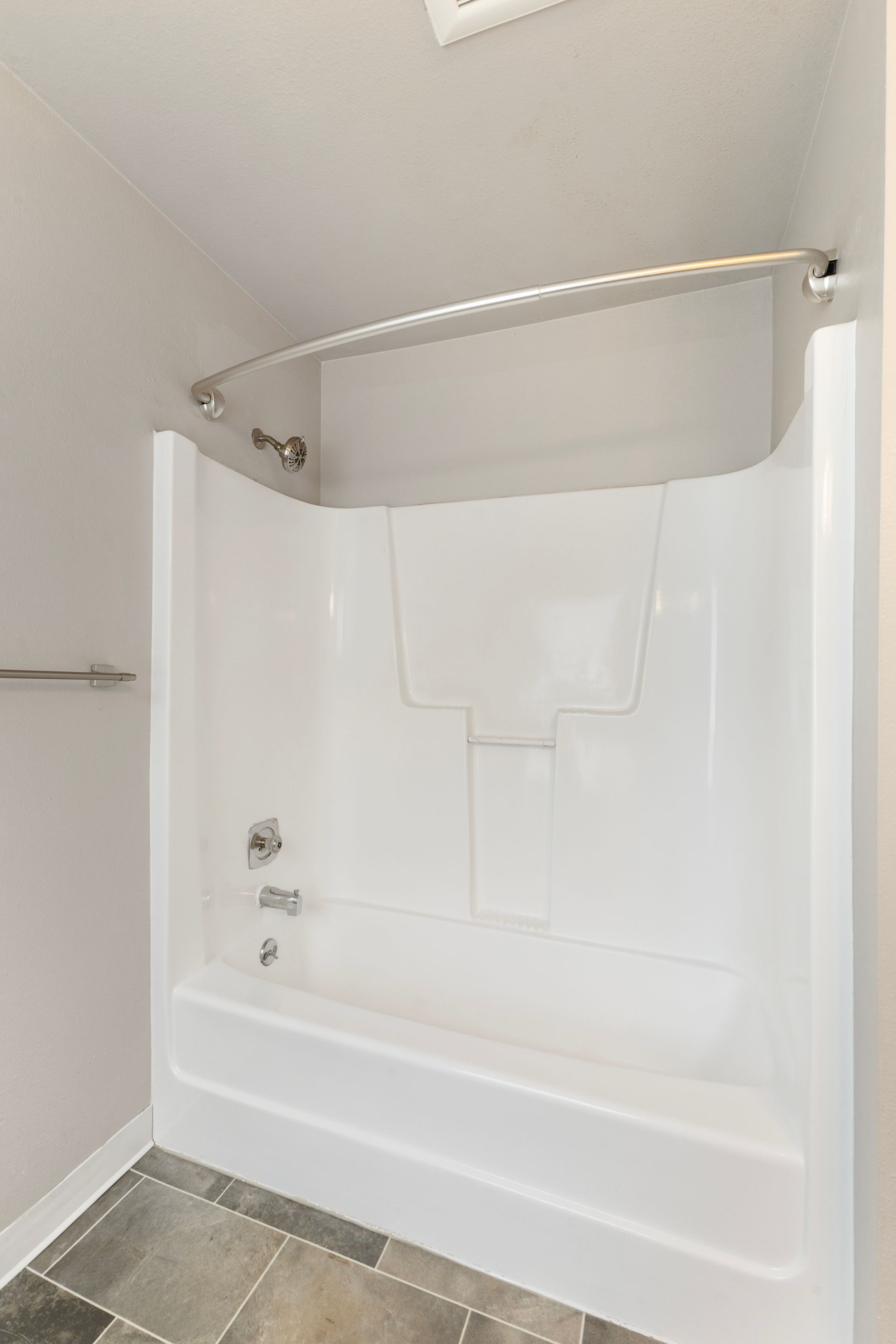 A bathroom with a bathtub and a shower stall.