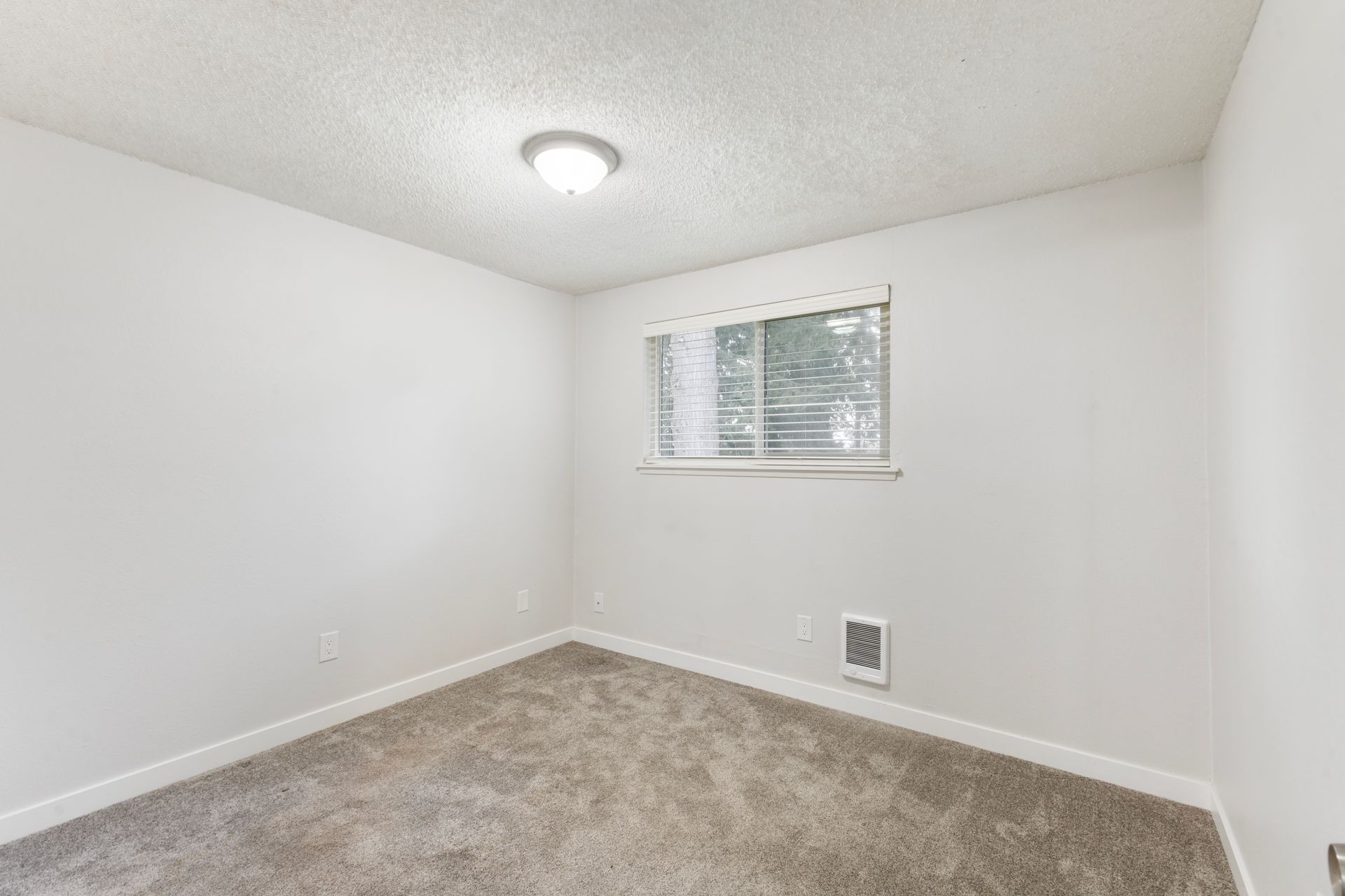 There is a window in the corner of the room.