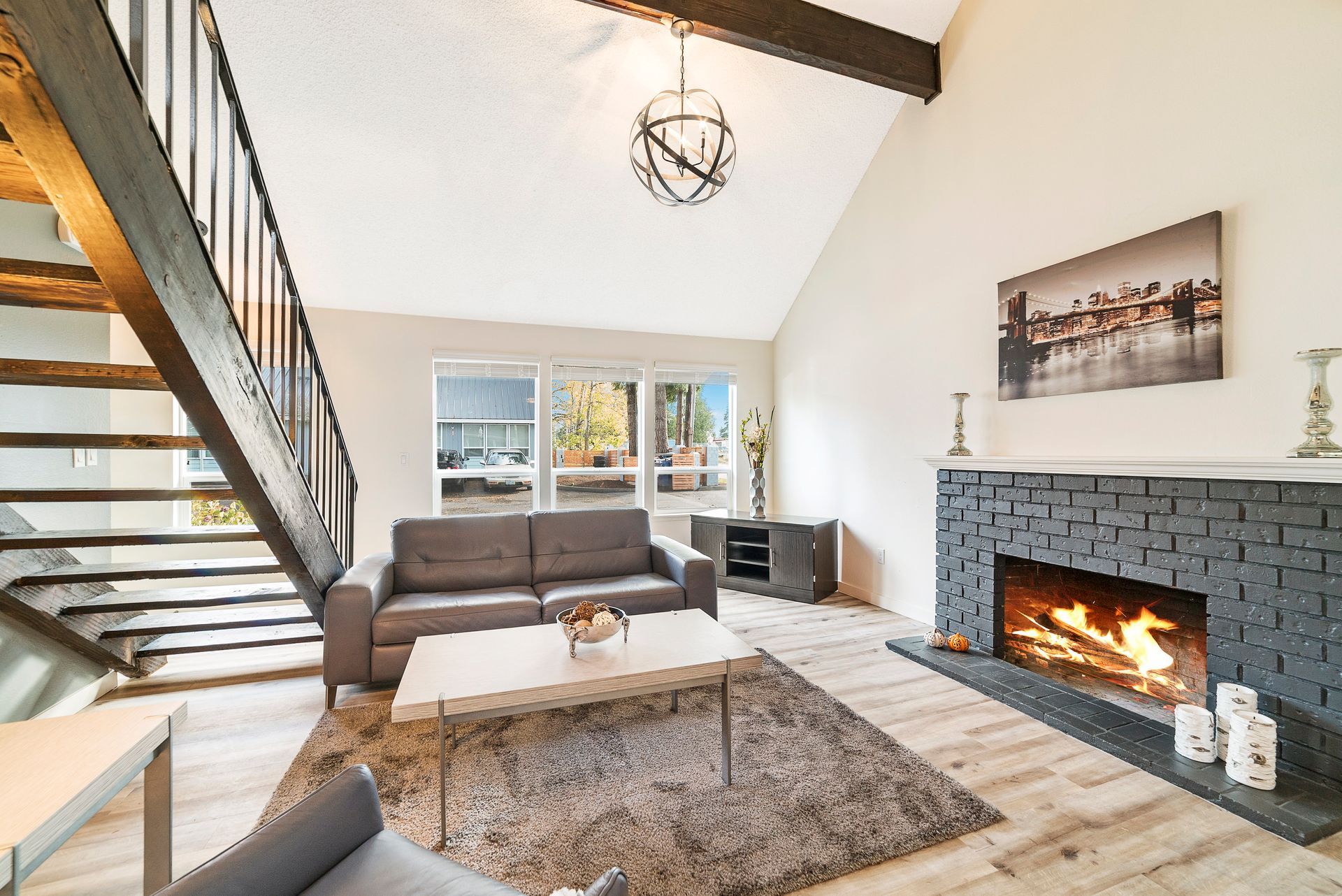 A living room with a fireplace and stairs