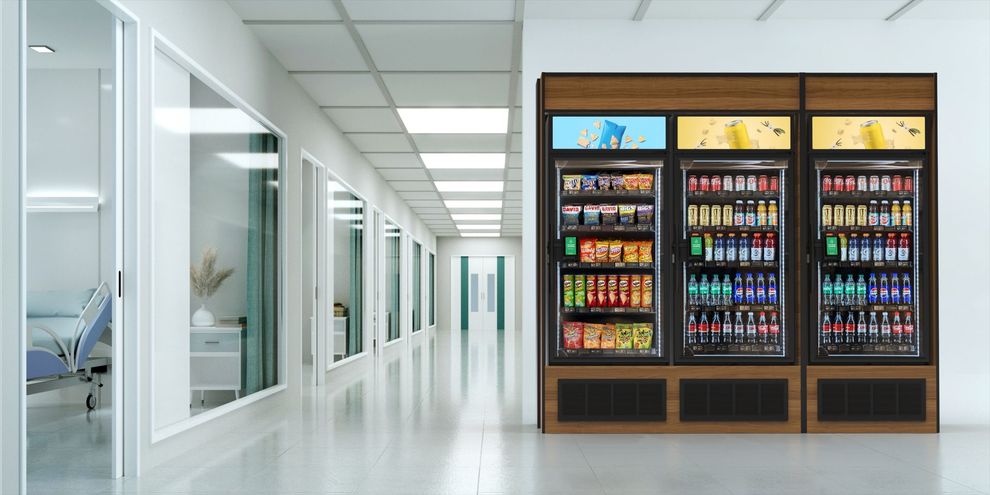 There are a lot of refrigerators in the hallway of a hospital.