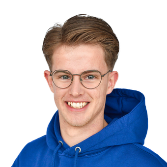 Een persoon met lichtbruin haar en een ronde bril, gekleed in een blauwe hoodie, lacht tegen een effen witte achtergrond.