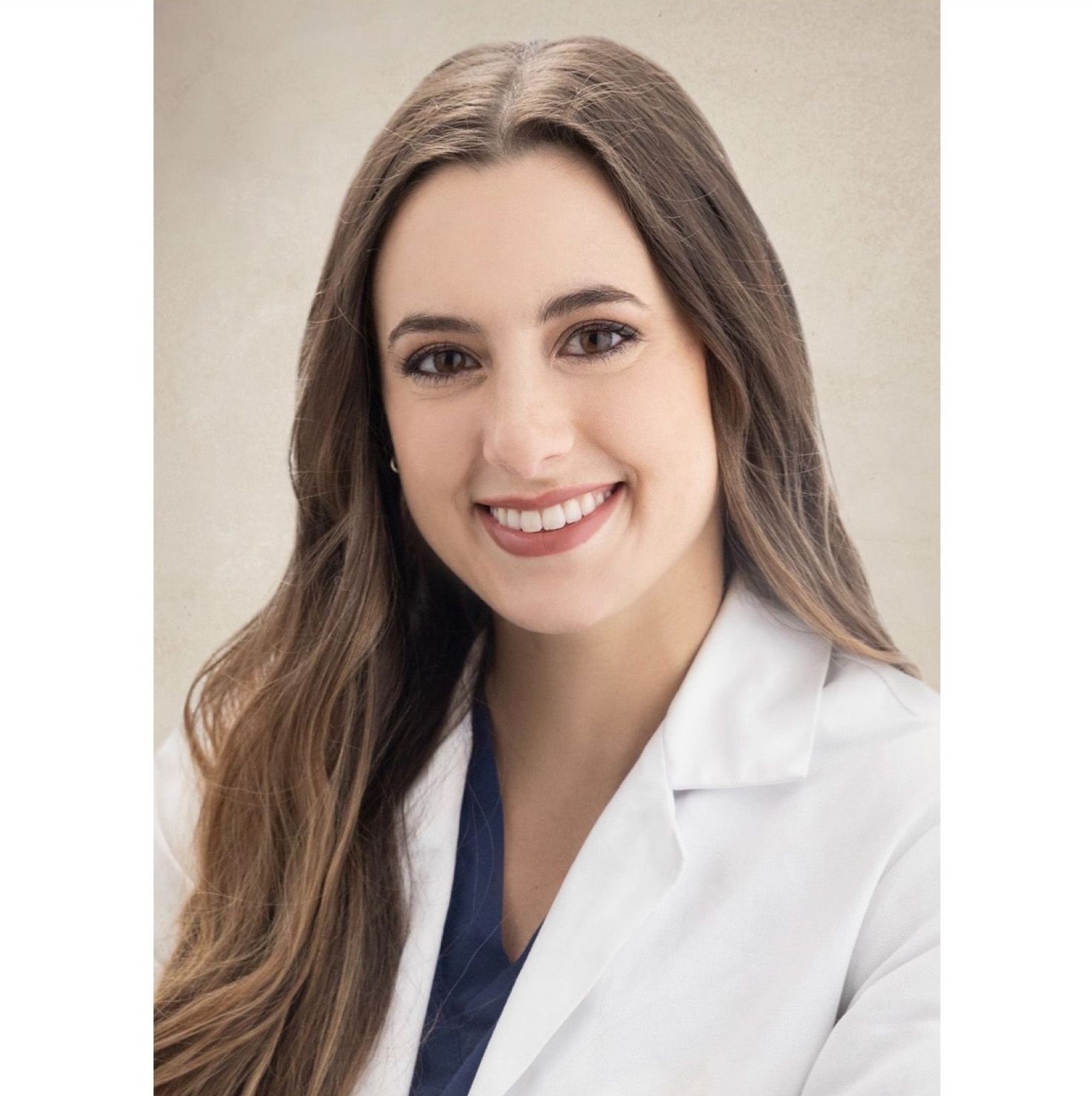 Smiling professional in a white coat against a soft beige background