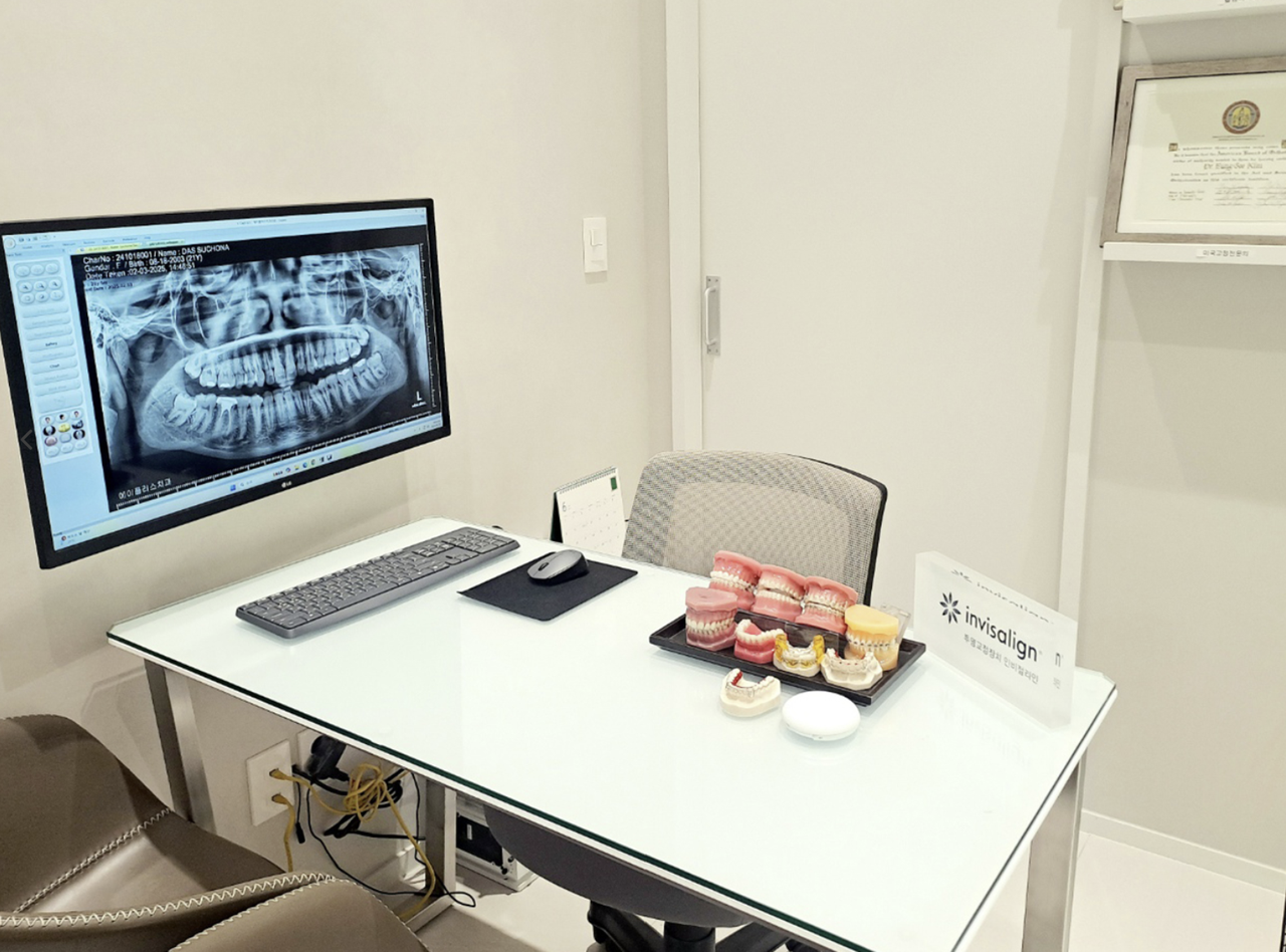 Consultation room with CT review screen at A Plus Dental Clinic