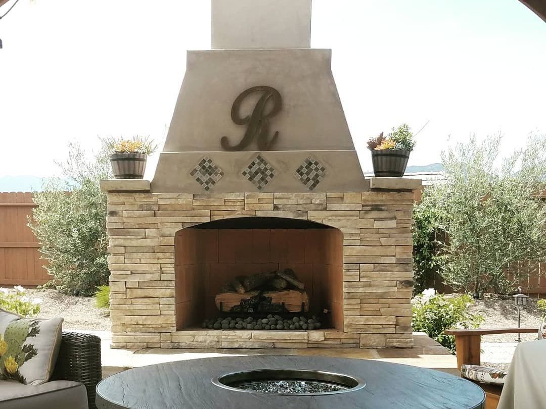A stone fireplace with the letter r on it