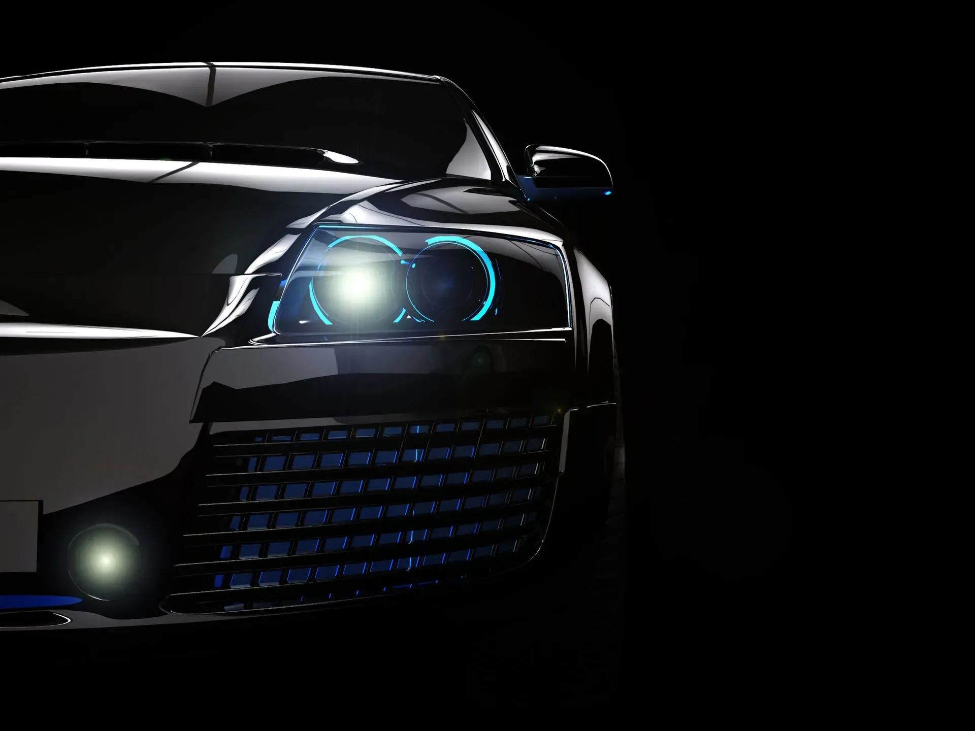 Front view of a black sports car with bright blue headlights in the dark