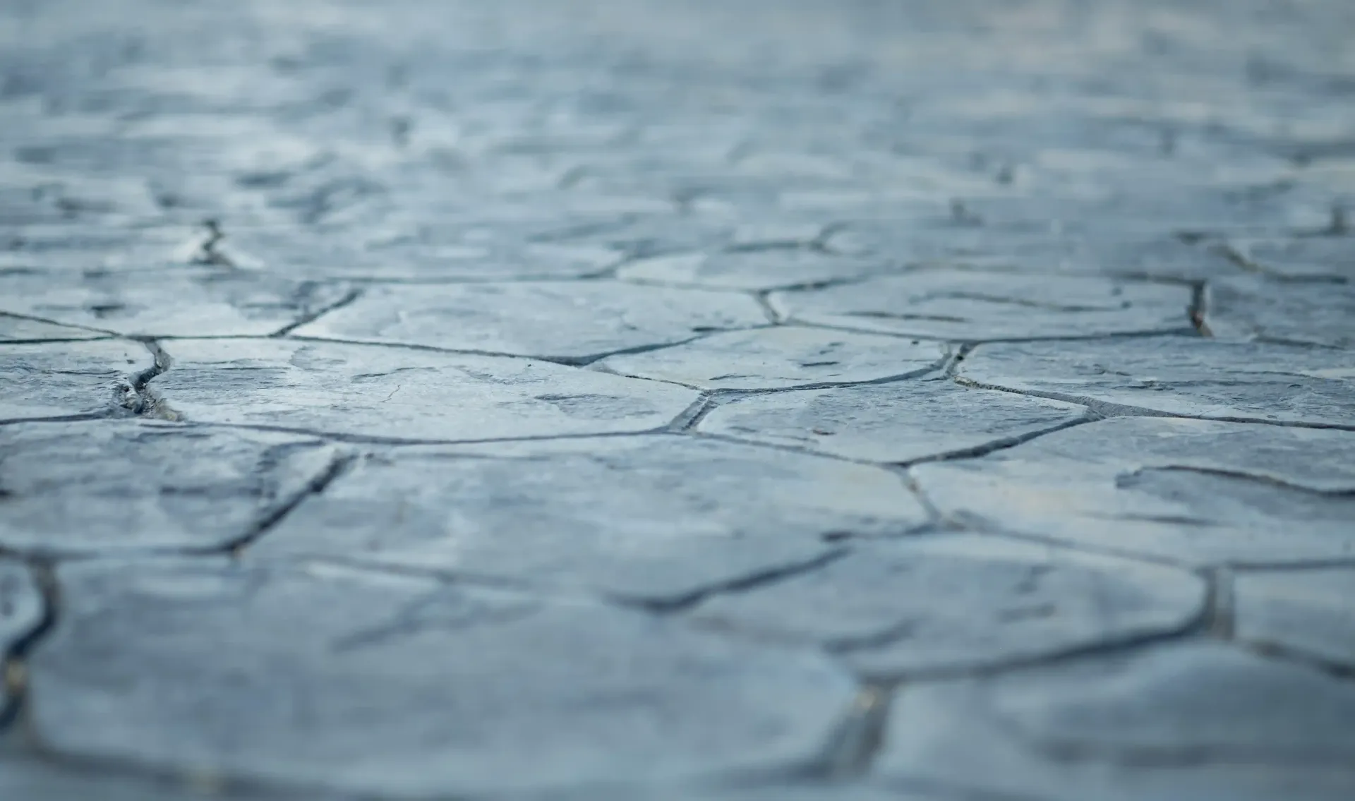 Textured, blue-gray stamped concrete surface, simulating a stone pattern.