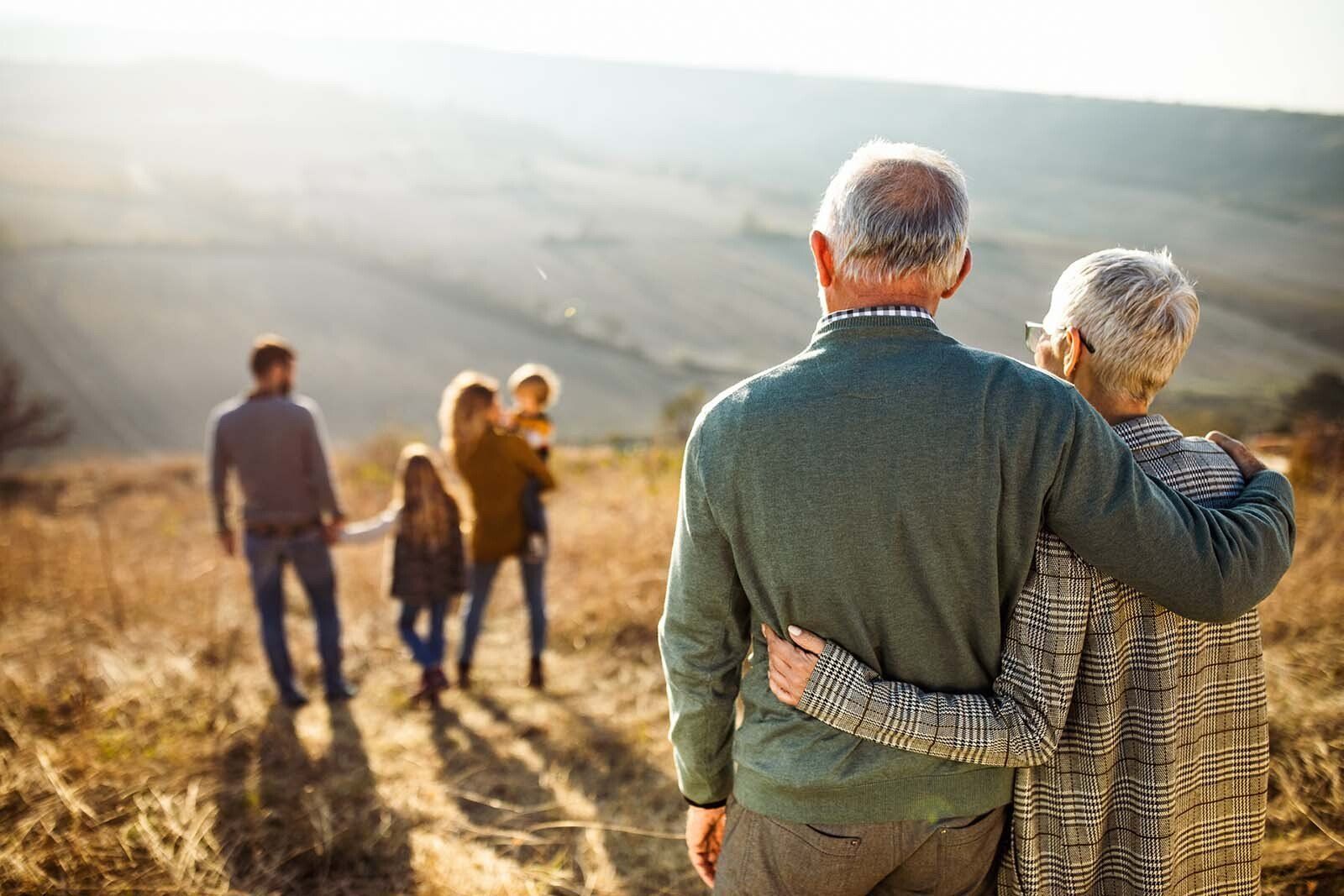 A group of people are standing on top of a hill, representing the topic of estate planning.