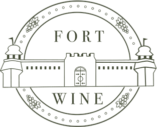 A logo for fort wine with a castle and grapes