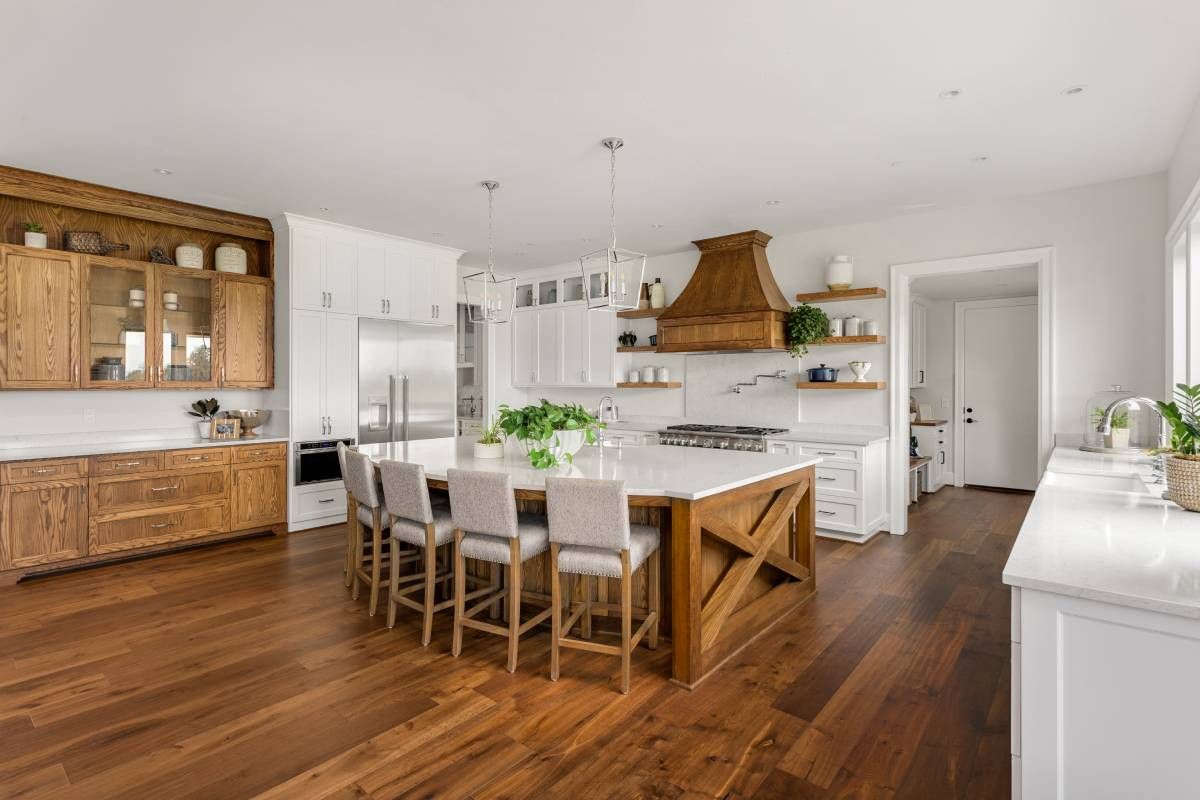 Warm wood furniture and decor in a luxury home kitchen at Schön Interiors near Braunfels, Texas