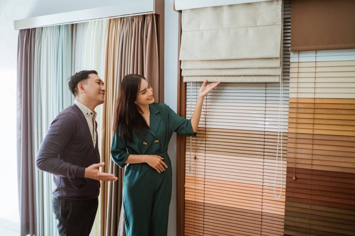 Two people looking at window treatments options for their home at Schön Interiors near Braunfels, Texas