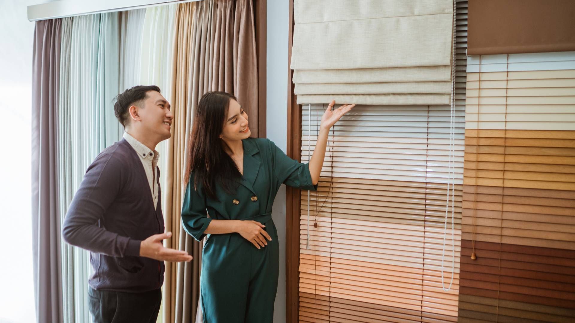 Two people looking at window treatments options for their home at Schön Interiors near Braunfels, Te