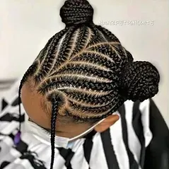 A woman with braids in a bun wearing a mask