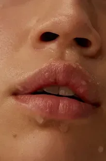 A close up of a person 's mouth with water coming out of it