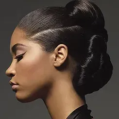 A close up of a woman 's face with her hair in a bun