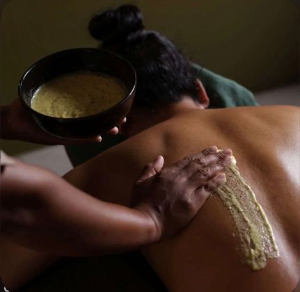 A woman is getting a body massage at a spa