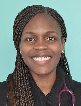 Woman with long, braided hair smiles, wearing a black top and a stethoscope. Blue background.