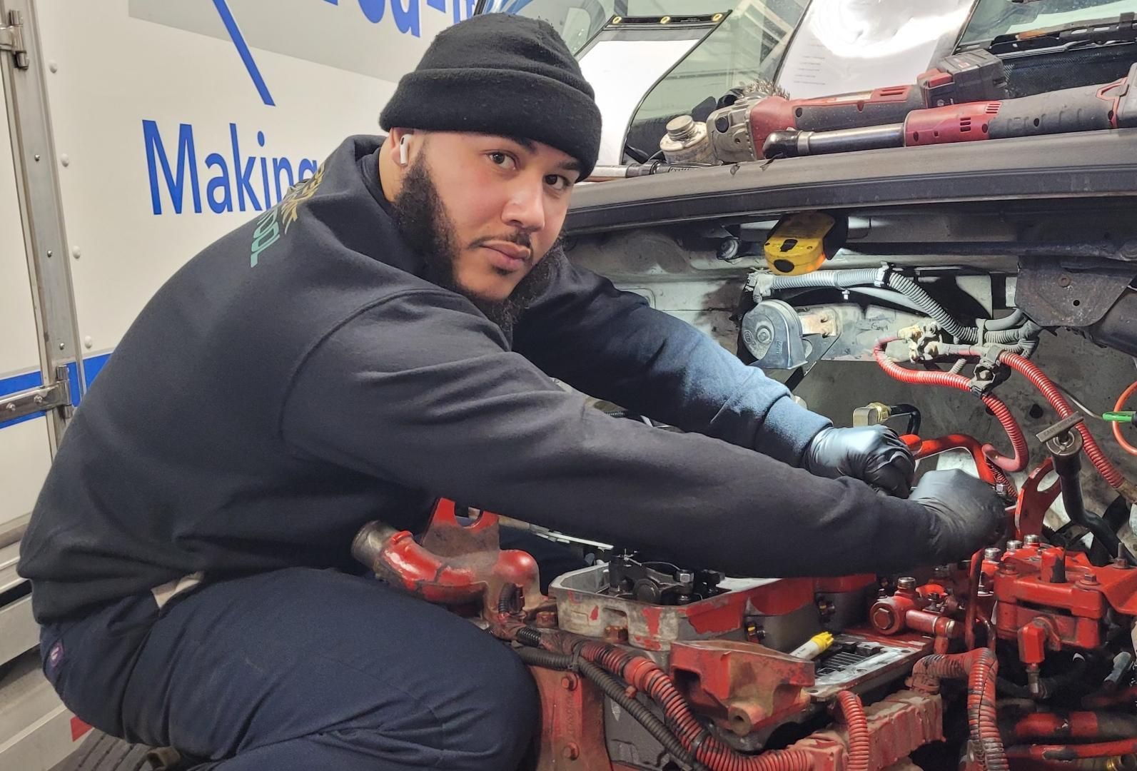 Luis Sandoval performing wiring repairs under the hood at Wallington Truck Repair, serving Wallington and Passaic, NJ.