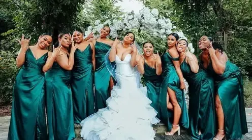 A bride and her bridesmaids are posing for a picture.