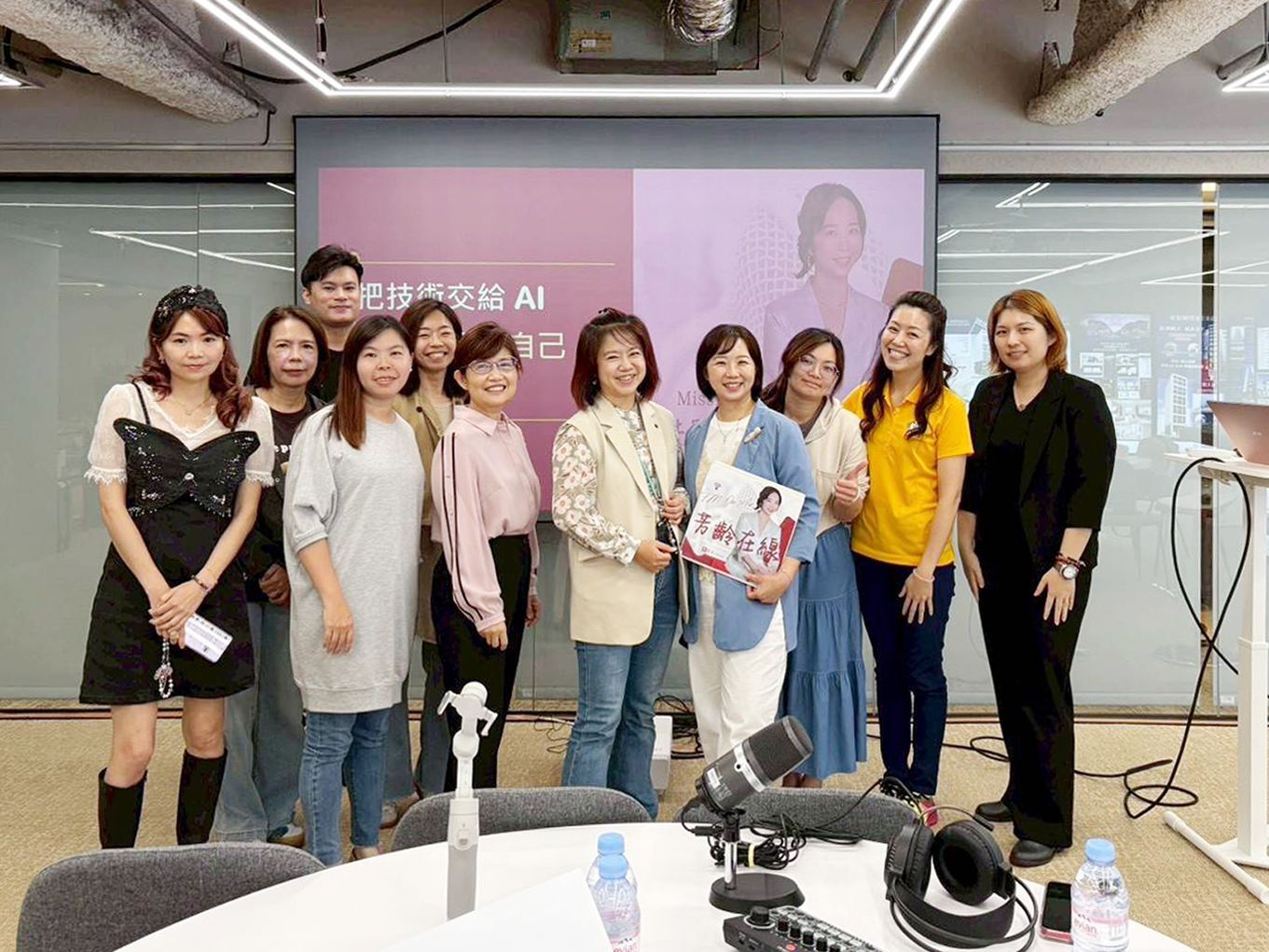 一群人在會議室裡的 AI 簡報投影幕前合影 posing