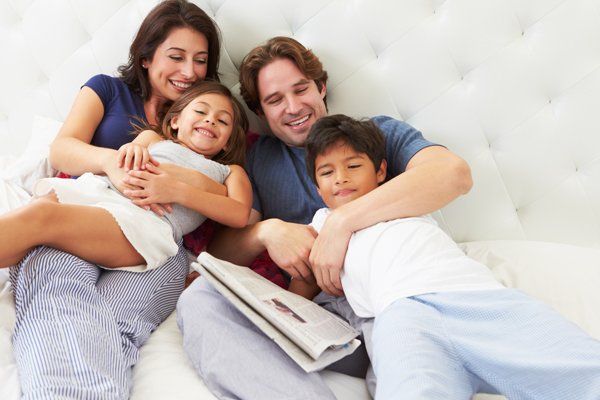 Family on Their Bed — Boone NC — Boone Heating & Air Conditioning Inc Family on Their Bed — Boone NC — Boone Heating & Air Conditioning Inc