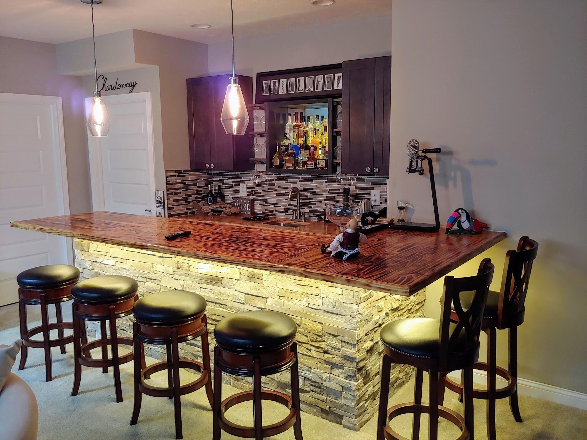 Bright empty home interior with gray walls, carpeted dining area, hardwood floor, and open kitchen doorway
